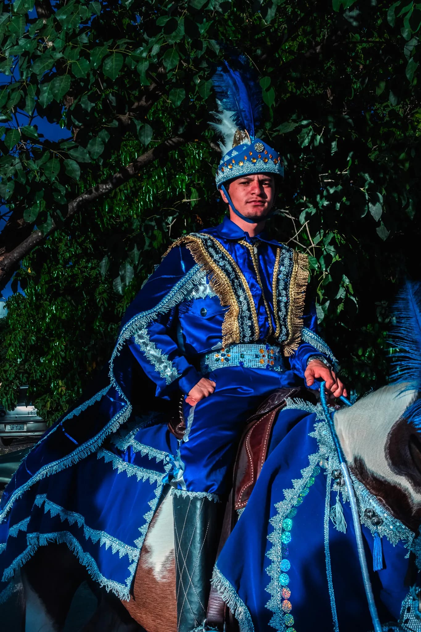 A Moor rider in blue and silver, mounted, seen from the front.